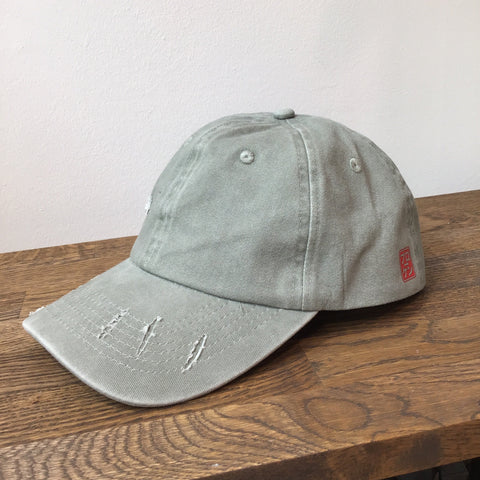 Gray cap with brand logo on a wooden surface